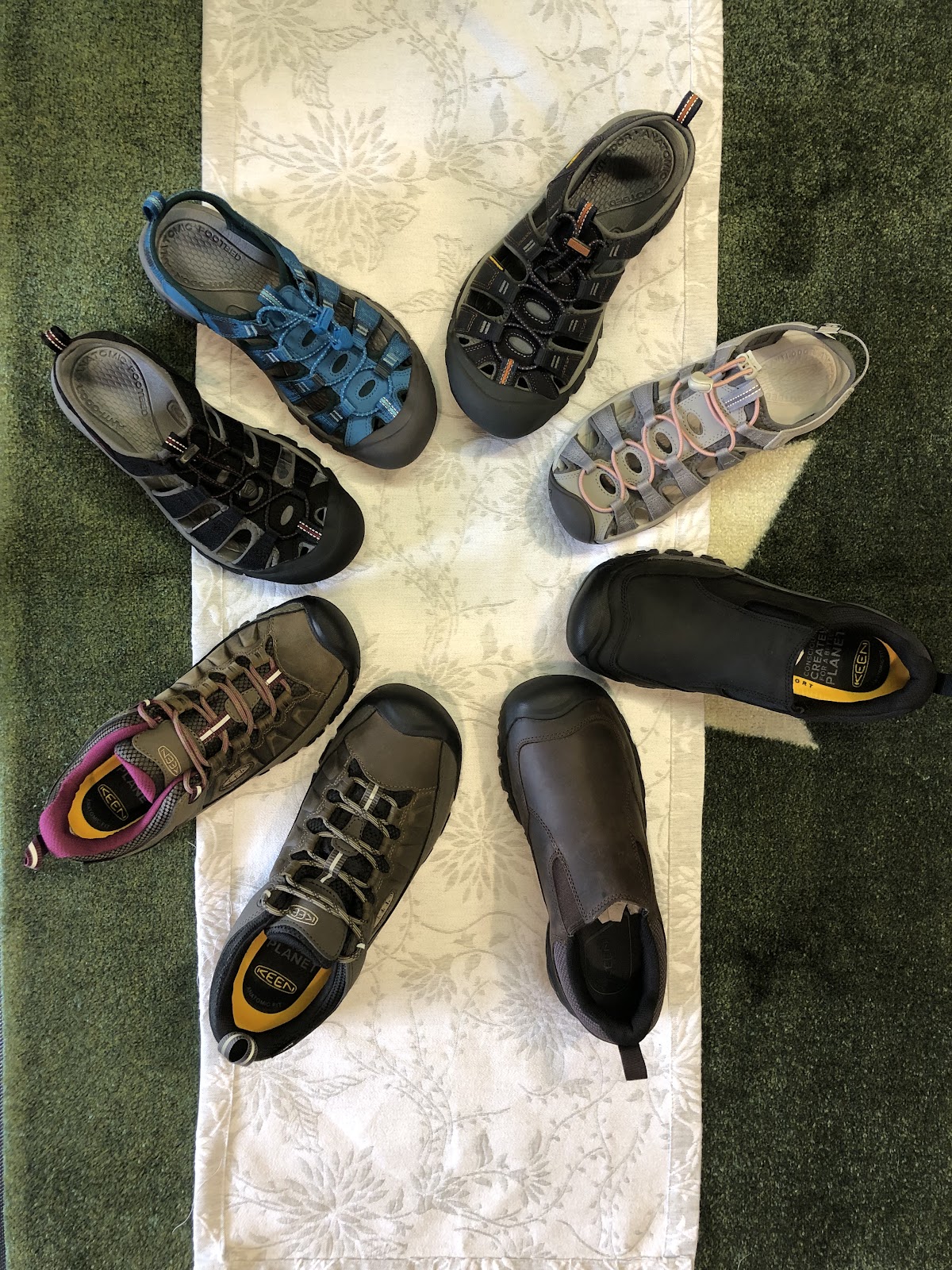 Shoe repair shop interior with equipment and repaired footwear at Varsity Shoe Repair